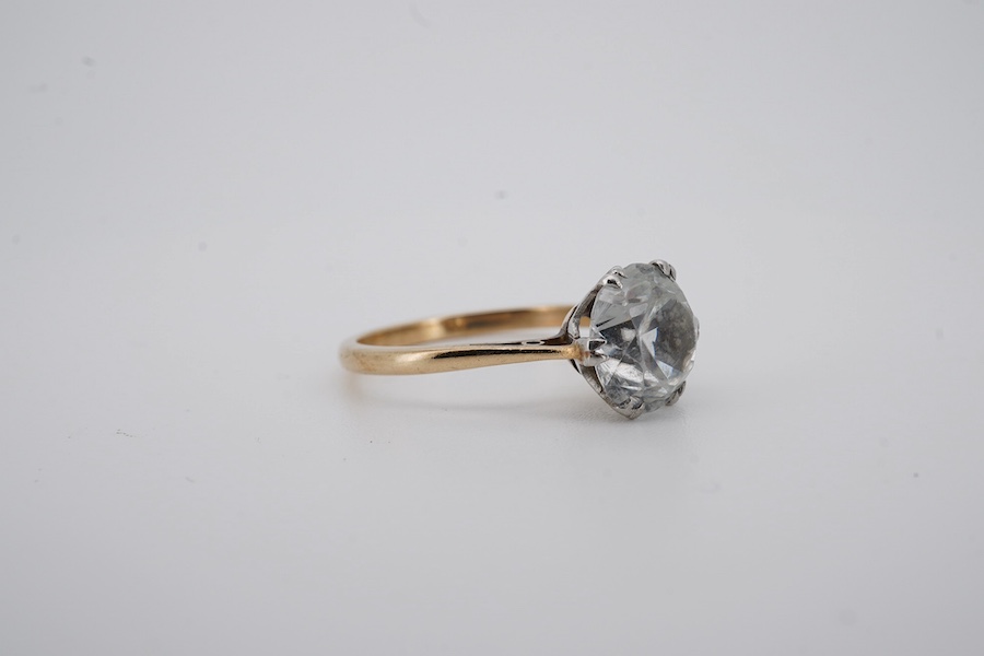 A yellow metal (stamped '9ct sil') and single stone white zircon set ring, gross weight 2.9 grams. Condition - poor to fair